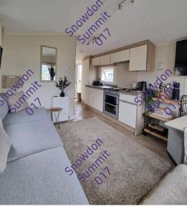 a living room with purple writing on the wall at Snowdon Summit 017 in Barmouth