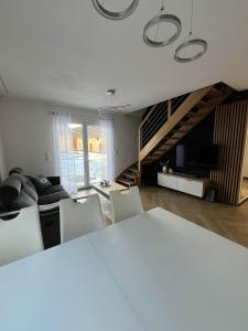 a living room with a white table and chairs at Opole Calm House in Opole