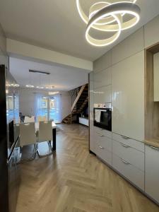 a kitchen and dining room with a chandelier at Opole Calm House in Opole