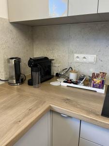 a kitchen counter with a coffee maker and a microwave at Opole Calm House in Opole +17 photos