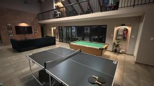 a living room with a ping pong table in it at House 110 in Hoedspruit