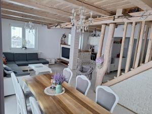 a living room with a table and a couch at Chata Lomňanka in Lomná