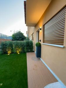 a house with a grass yard next to a building at Double A Luxury Room in Olbia