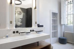 a bathroom with a white sink and a mirror at Château de Roquefoulet Luxury Guesthouse & Spa in Montgeard +37 photos