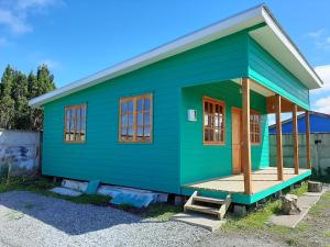 a green tiny house sitting on top of a driveway at Cabañas de Campo MARBAJA in Puerto Montt