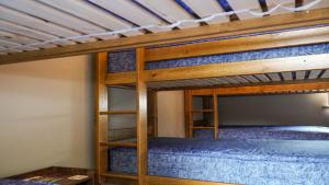 a bedroom with two bunk beds with blue sheets at 3 Peaks Bunkroom in Settle