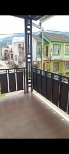 an open balcony with a view of a house at Kulla villa dieng in Wonosobo