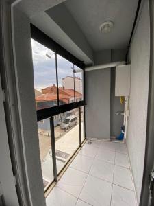 an empty room with a large window in a building at Kent KONAKLAMA in Uşak