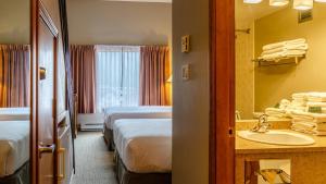 a hotel room with two beds and a sink at Cahilty #434 home in Sun Peaks