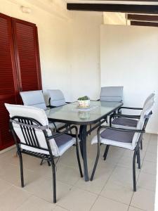 a dining room table with chairs and a bowl on it at Apartmani Hranjec in Ugljan