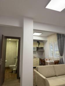 a living room with a couch and a bathroom at Le Grace, Urban Retreat near Near CityCenter & Sea in Thessaloniki