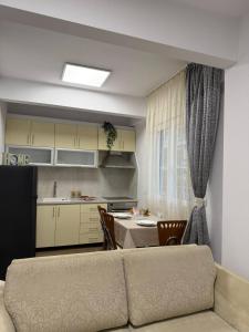 a living room and kitchen with a couch and a table at Le Grace, Urban Retreat near Near CityCenter & Sea in Thessaloniki