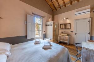 a bedroom with a bed and a window and a sink at B&B Il Molinello in Asciano +58 photos