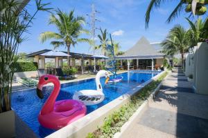 two swans in a swimming pool at a resort at Impress Resort, Phuket - Free scheduled shuttle from Hotel to Phuket Airport in Thalang