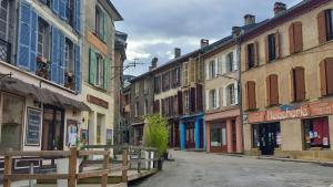 an empty street in a town with buildings at Apparemment spacieux in Massat