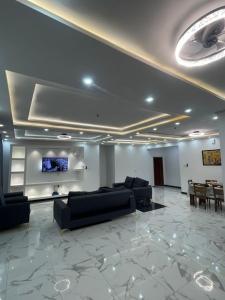 a living room with couches and a flat screen tv at JudEls SA Guest House in Accra