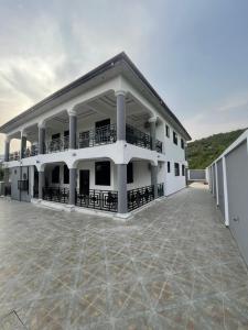 a large white building with a large courtyard at JudEls SA Guest House in Accra