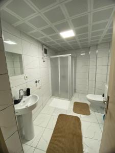 a bathroom with a shower and a sink and a toilet at Kent KONAKLAMA in Uşak +13 photos