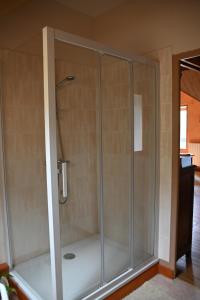 a shower with a glass enclosure in a room at Le Deyran in Égliseneuve-dʼEntraigues