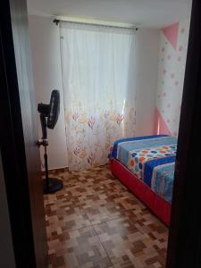 a bedroom with a bed and a camera in it at Apartamento Aboleda Campestre in Ibagué