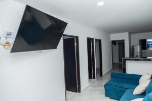 a living room with a flat screen tv on a wall at Apartamentos King Arthur in Punta Seca