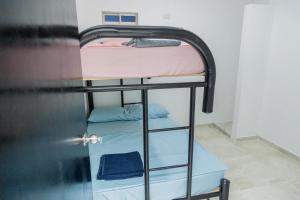 a couple of bunk beds in a room at Apartamentos King Arthur in Punta Seca +2 photos