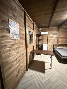 a room with a wooden wall with a bench in it at Area Sosta Camper Policoro in Policoro