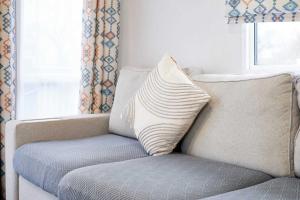 a pillow sitting on a couch with a window at Host & Stay - Long View Lodge in Felton
