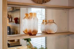four glass bottles sitting on a shelf in a kitchen at Host & Stay - Long View Lodge in Felton