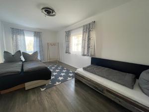 a bedroom with two beds and a couch in it at Exklusive Haushälfte zentrumsnah in Magdeburg +6 photos