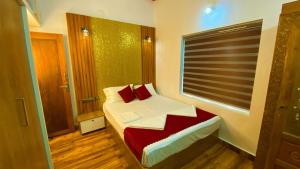 a small bedroom with a bed and a window at Karmalhills Homestay in Tindummal