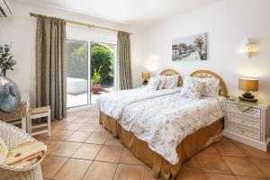a bedroom with a bed and a balcony at Casa Juniper in Praia do Carvoeiro +31 photos