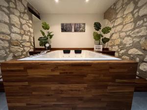 a large bath tub in a bathroom with plants at Appart Spa Privatif in Reims