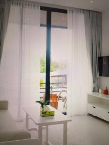 a living room with a table in front of a window at Star light hotel in Monterrey