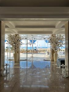 a lobby with two vases with flowers in it at Borg El Arab Beach Resort in Dawwār ‘Abd al Qādir Qāsim +109 photos
