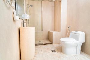 a bathroom with a toilet and a shower at Golden Garden Al Corniche in Dammam