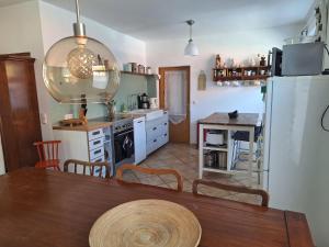 a kitchen with a table and a refrigerator at Große Ferienwohnung in Flecken Zechlin in Rheinsberg