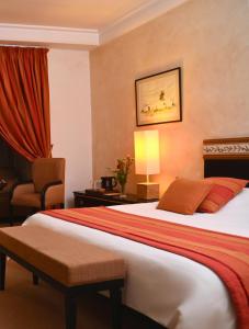 a hotel room with a bed and a chair at Borj Dhiafa in Sfax +49 photos