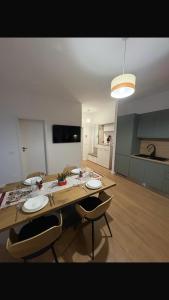 a kitchen with a wooden table and two chairs at La felix bulevard in Biharia