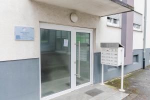 an entrance to a building with a glass door at Dreiländer-Blick Apartment 2 Schlafzimmer in Lörrach