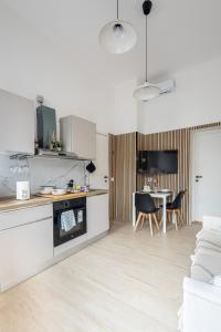 a kitchen and living room with a table and chairs at B&B di Dante in Legnano