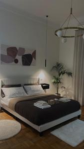 a bedroom with a large bed and a potted plant at B&B di Dante in Legnano +5 photos
