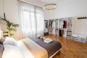 a bedroom with a bed with towels on it at B&B di Dante in Legnano