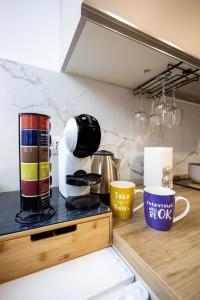 a kitchen counter with cups on top of it at B&B di Dante in Legnano