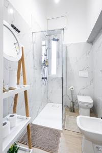 a white bathroom with a shower and a toilet at B&B di Dante in Legnano