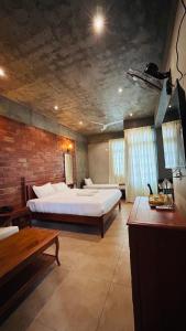 a large room with two beds and a table at Savana Stay - A Boutique Hotel in Pondicherry +111 photos