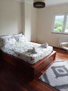 a bedroom with a large bed with a wooden frame at Casa D Aitana in Pardaces de Arriba +23 photos