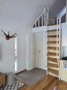 a room with a staircase and a door at Salmistu Saunamaja in Salmistu