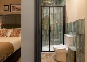 a bathroom with a bed and a toilet and a shower at Brewhouse & Kitchen - Bournemouth - Southbourne in Bournemouth +60 photos