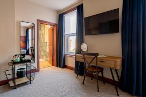 a hotel room with a desk and a window at Brewhouse & Kitchen - Bournemouth - Southbourne in Bournemouth